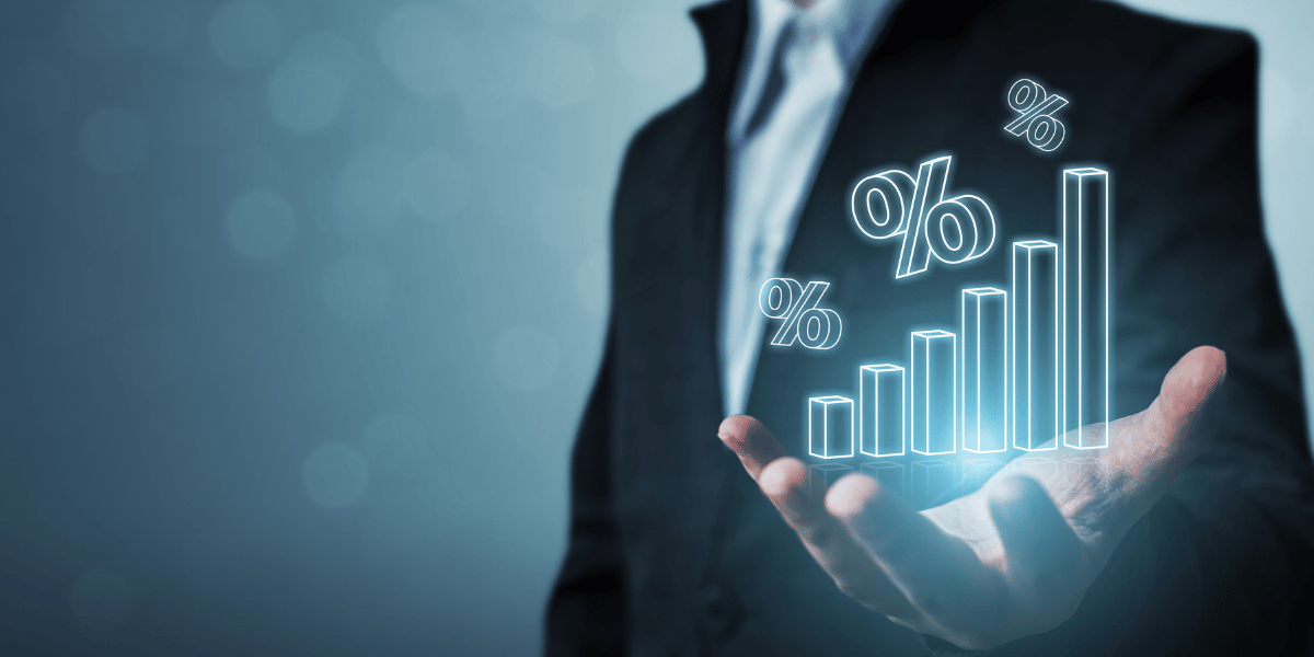 A person holding a holographic image of a graph demonstrating the concept of rising interest rates